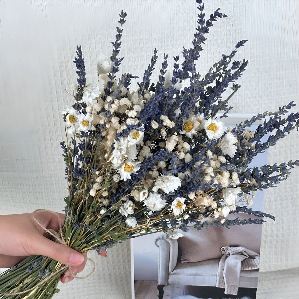 A long dried lavender flower bouquet in a vase, showing white or pink colour options.