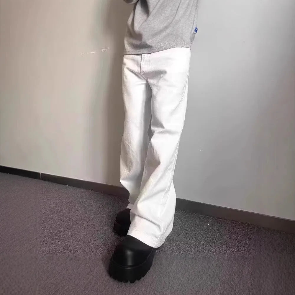 Men's straight-leg white denim jeans with mid-waist and zipper fly, shown in a summer setting.
