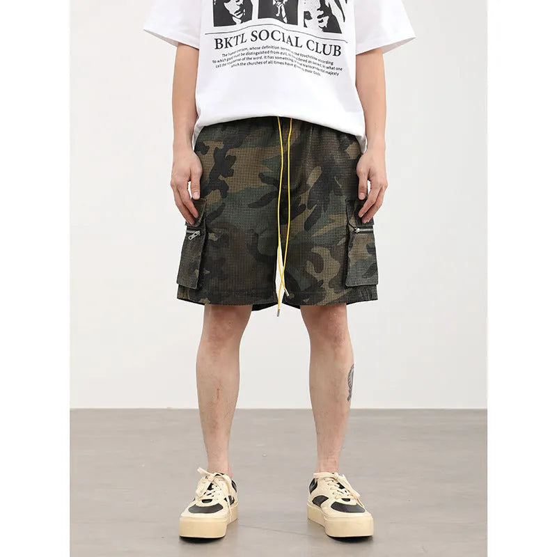 Men's camouflage multi-pocket work shorts showing cropped length and pocket details