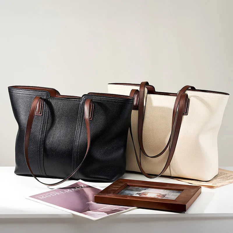 Women's black genuine cowhide leather commuter bag showing internal zipper change bag, mobile phone pocket, file compartment, and crossbody strap