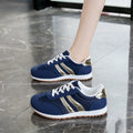 Blue women's lace-up casual sports shoes with cross straps and a flat rubber sole.