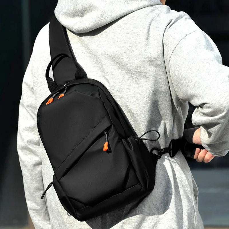Black mens crossbody bag with adjustable strap showing waterproof polyester material