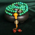 Natural turquoise gemstone bracelet with 108 round polished beads on a string.