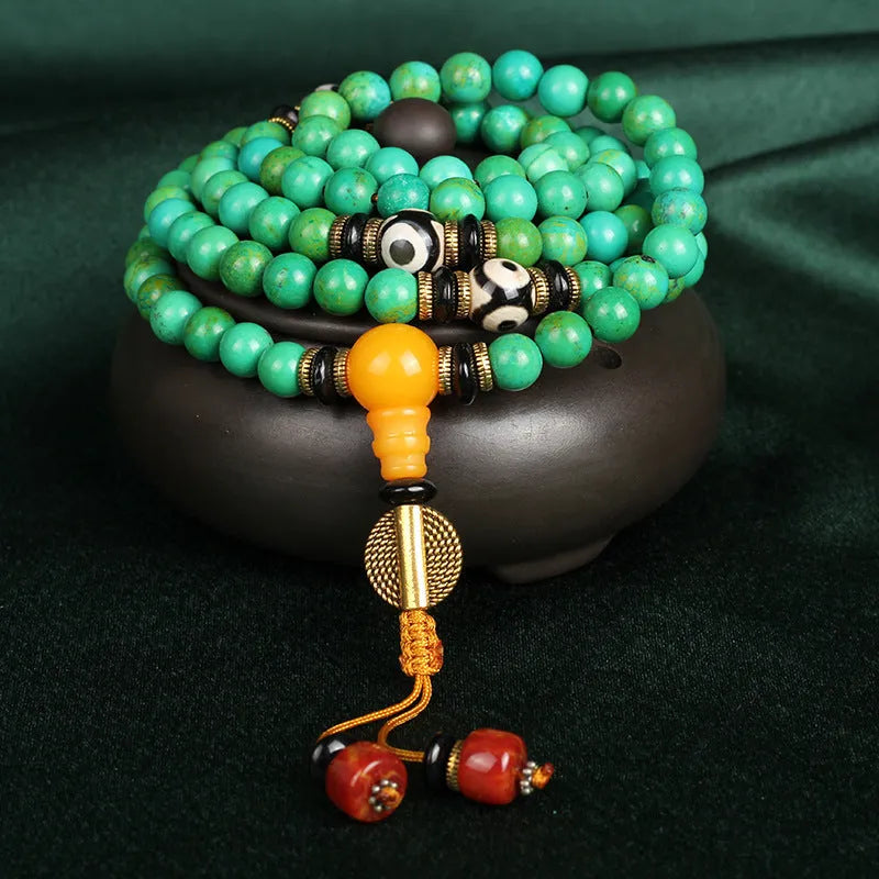 Natural turquoise gemstone bracelet with 108 round polished beads on a string.