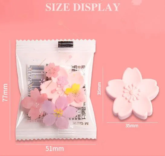 Pack of cherry blossom design student erasers on a desk, shown to leave no marks or debris.