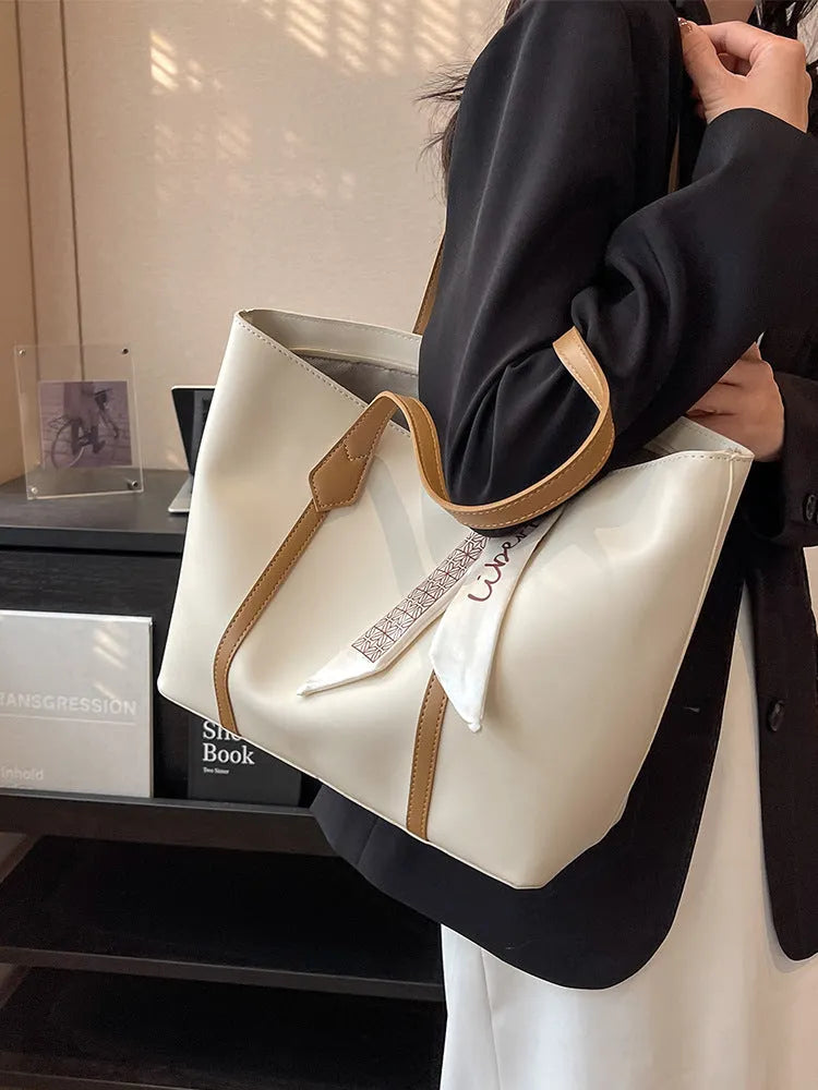 Soft tote bag with crossbody strap showing internal zipper compartment and khaki colour option