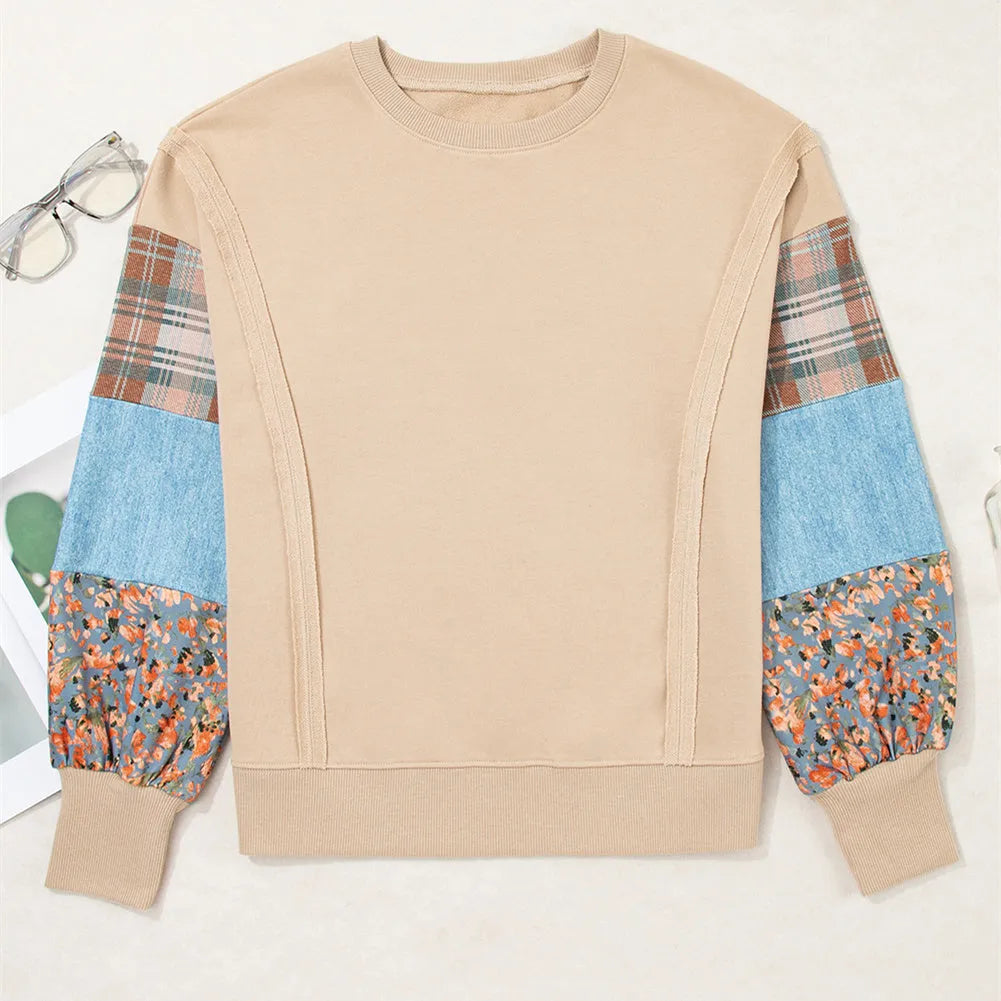 Women's beige and red plaid stitch long-sleeved loose pullover top on a hanger.