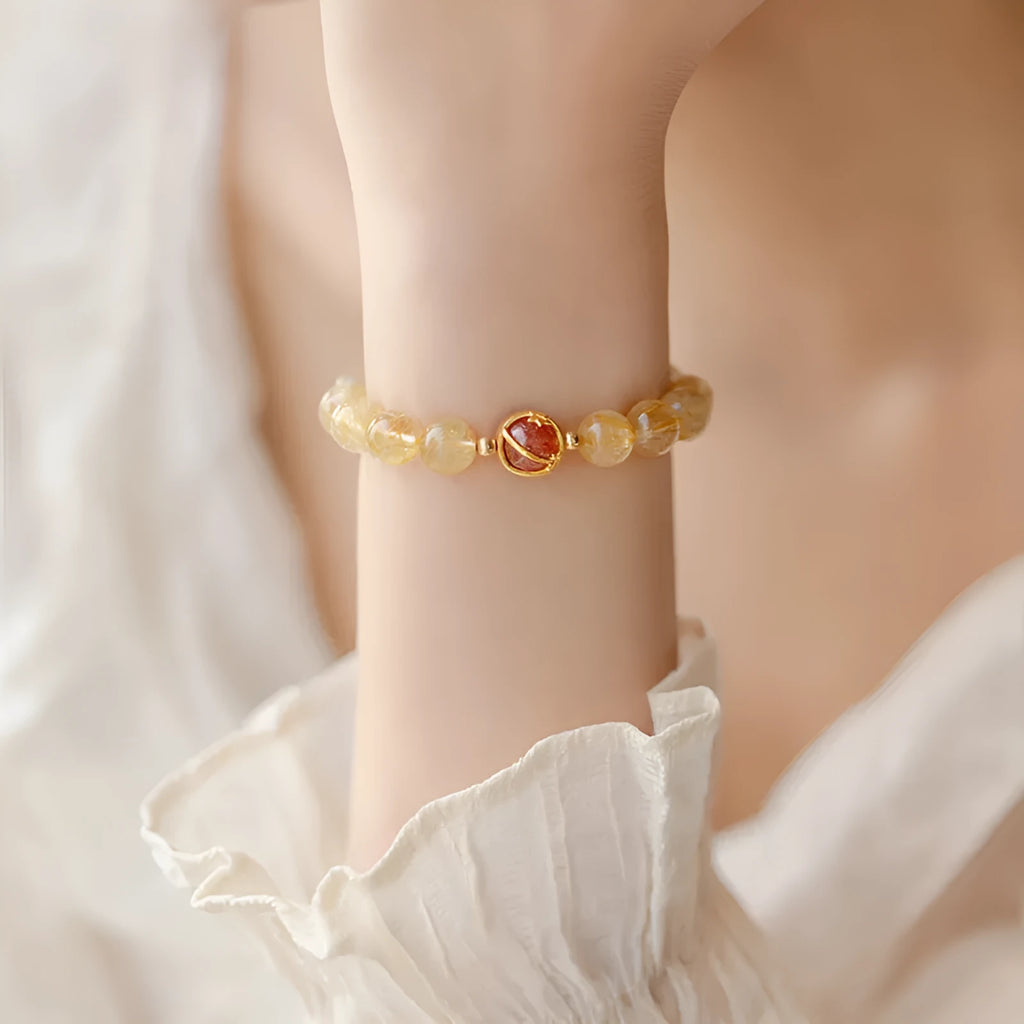 Gold rutilated quartz crystal bracelet with diamond-cut beads on stretch cord in Korean style