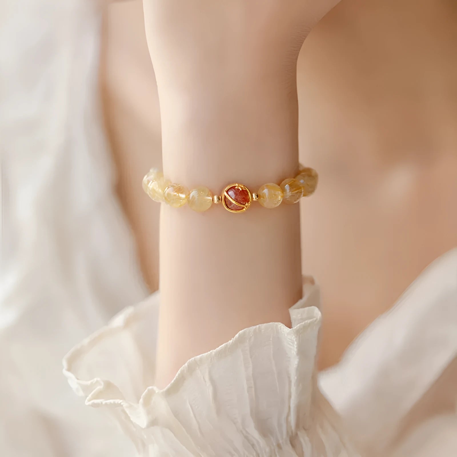 Gold rutilated quartz crystal bracelet with diamond-cut beads on stretch cord in Korean style
