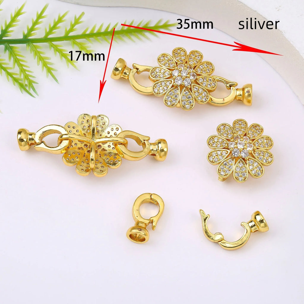 Small gold colour necklace clasp chain buckle on a white background