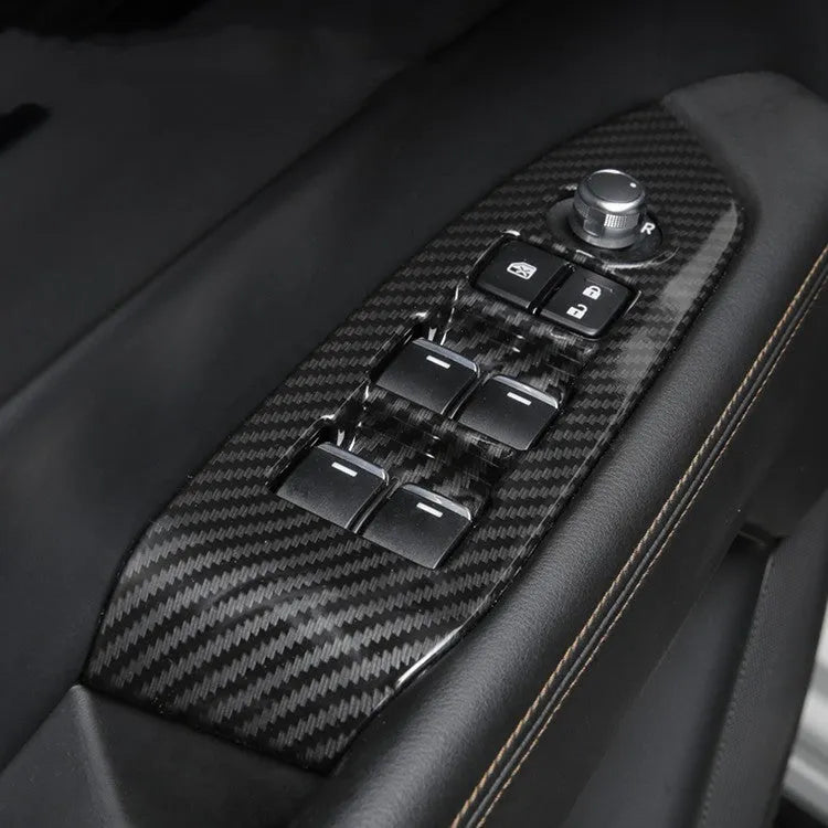 Pair of carbon fibre effect ABS plastic steering wheel frame covers for adhesive installation.