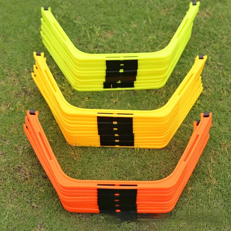 Set of six foldable yellow hexagon plastic agility training rings laid out on grass.