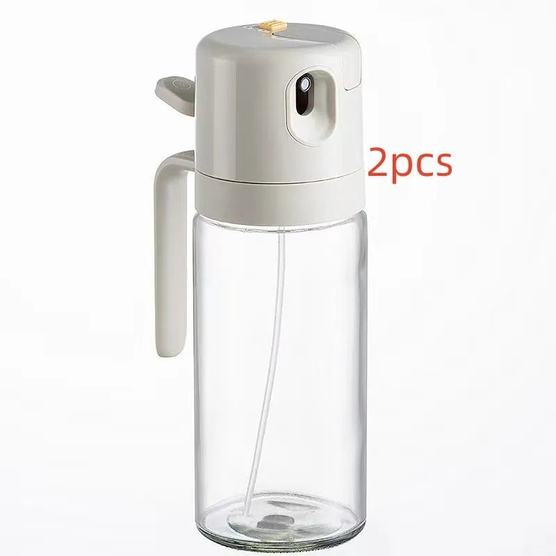 Warm grey glass 2-in-1 oil sprayer and pourer bottle with switchable cap on kitchen counter