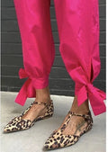 Leopard print women's pumps with pointed toe, chunky 1-3 cm heel, and cross shoulder straps in low-top design