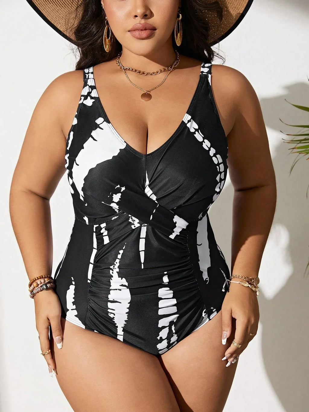 Black plus size one-piece swimsuit on a hanger, showing sleeveless conservative design.