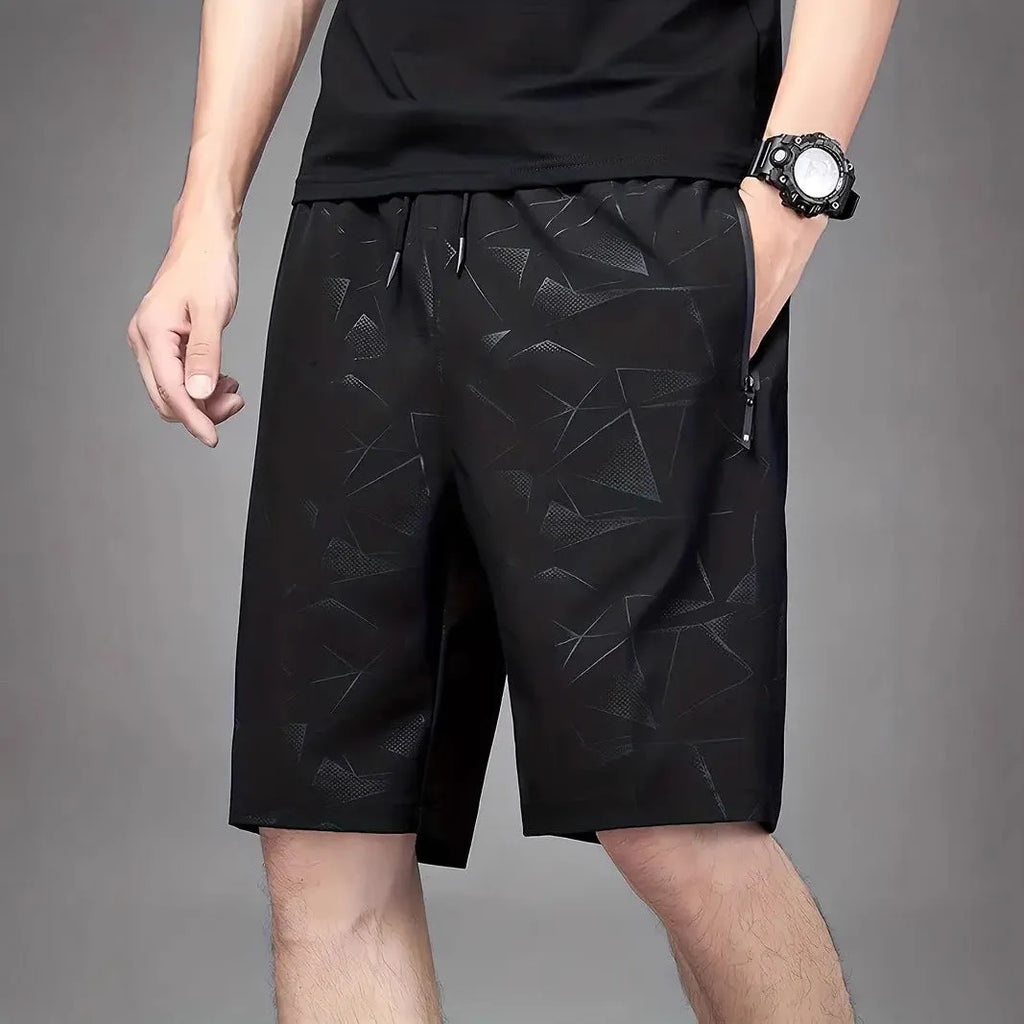 Men's loose sports shorts in black, grey, or blue with printed design, elastic waistband, and fifth pants length.