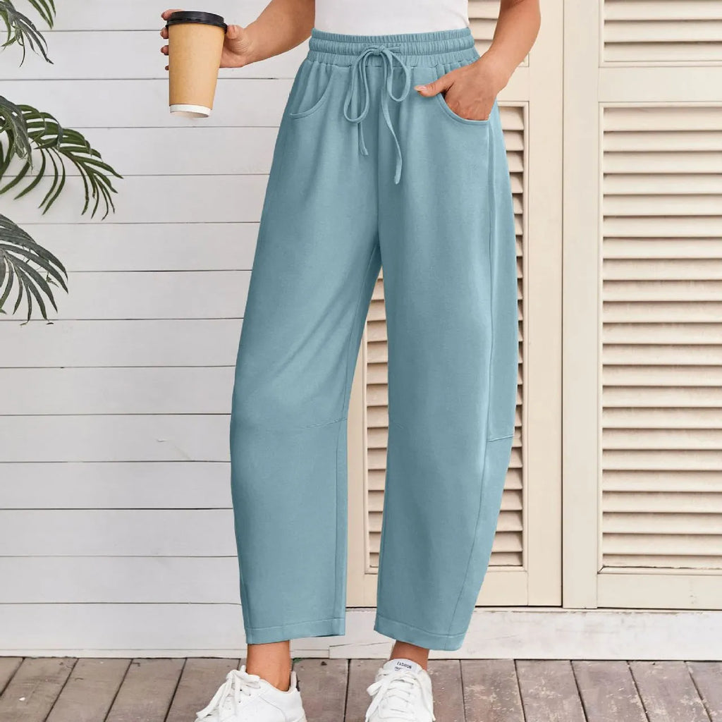 Loose sports cropped sweatpants in hot light grey with elastic waist and drawstring, showing collage/stitching craft details