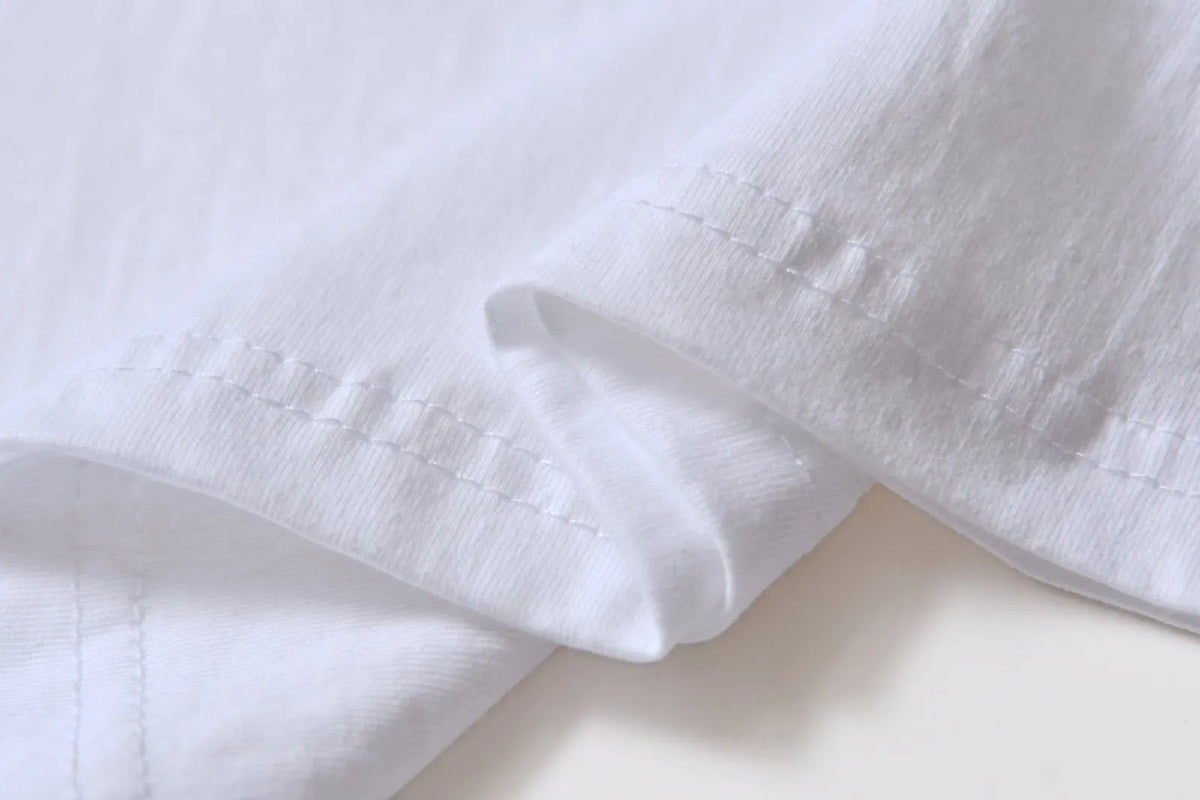 White cotton t-shirt overalls with round neck and short sleeves in patterned design