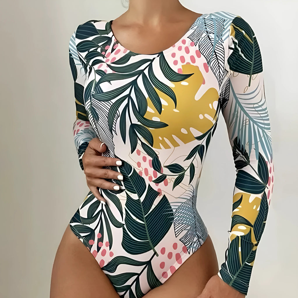 Women's backless one-piece swimsuit with floral print in blue colour showing bikini split design