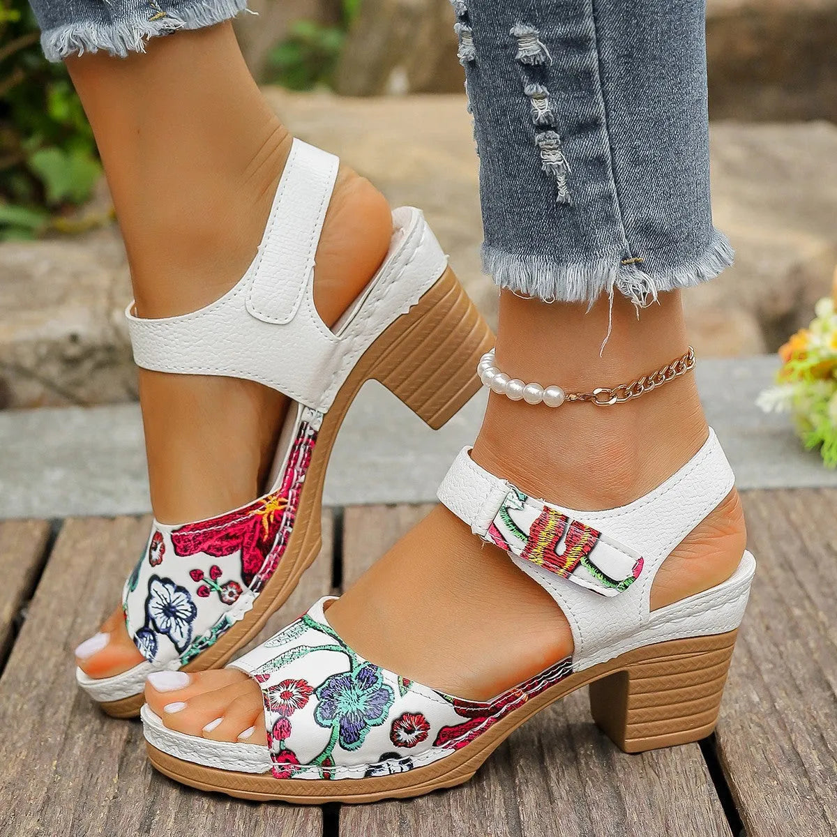 White women's high heel sandals showing velcro buckle fastening and rubber sole