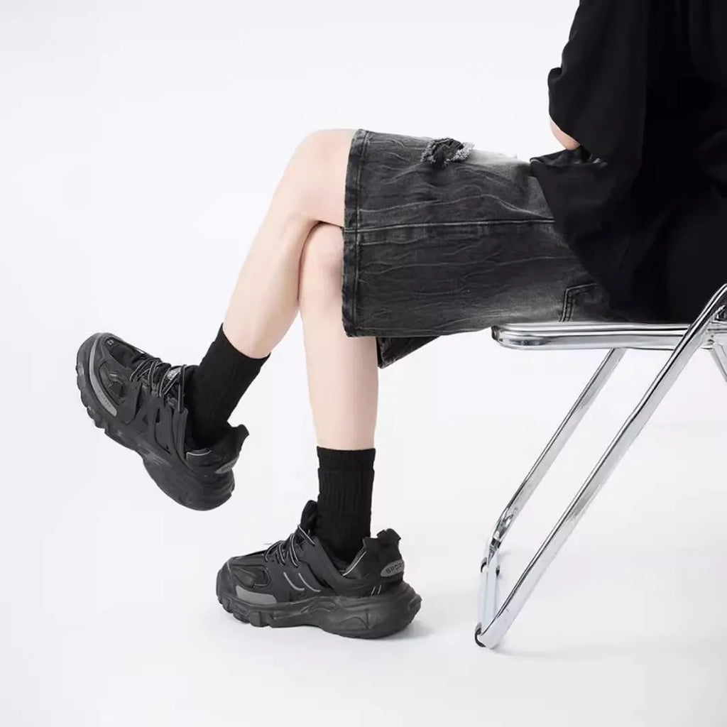 Retro loose-fit ripped denim shorts in washed black or blue with distressed detailing