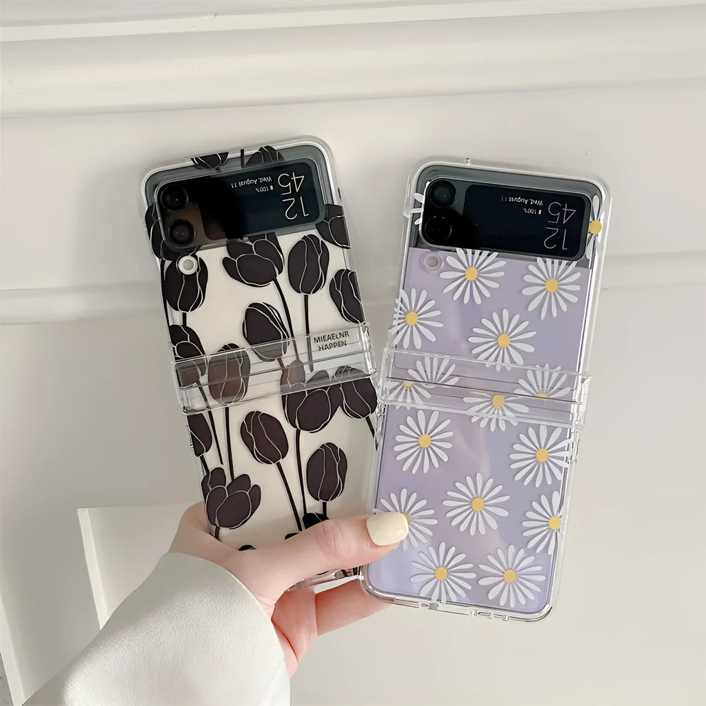 Clear Samsung Galaxy Z Flip phone case with floral pattern, available in Daisy and Tulip designs.