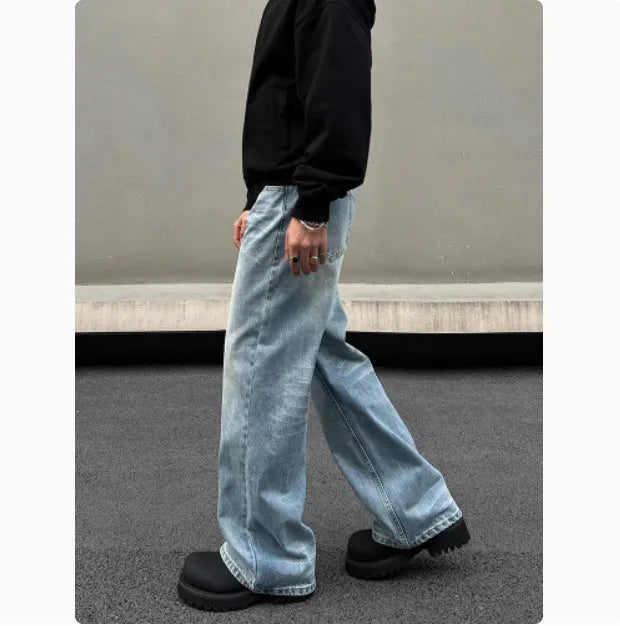 Men's blue straight-leg jeans with whisker wash detailing and a flared leg.