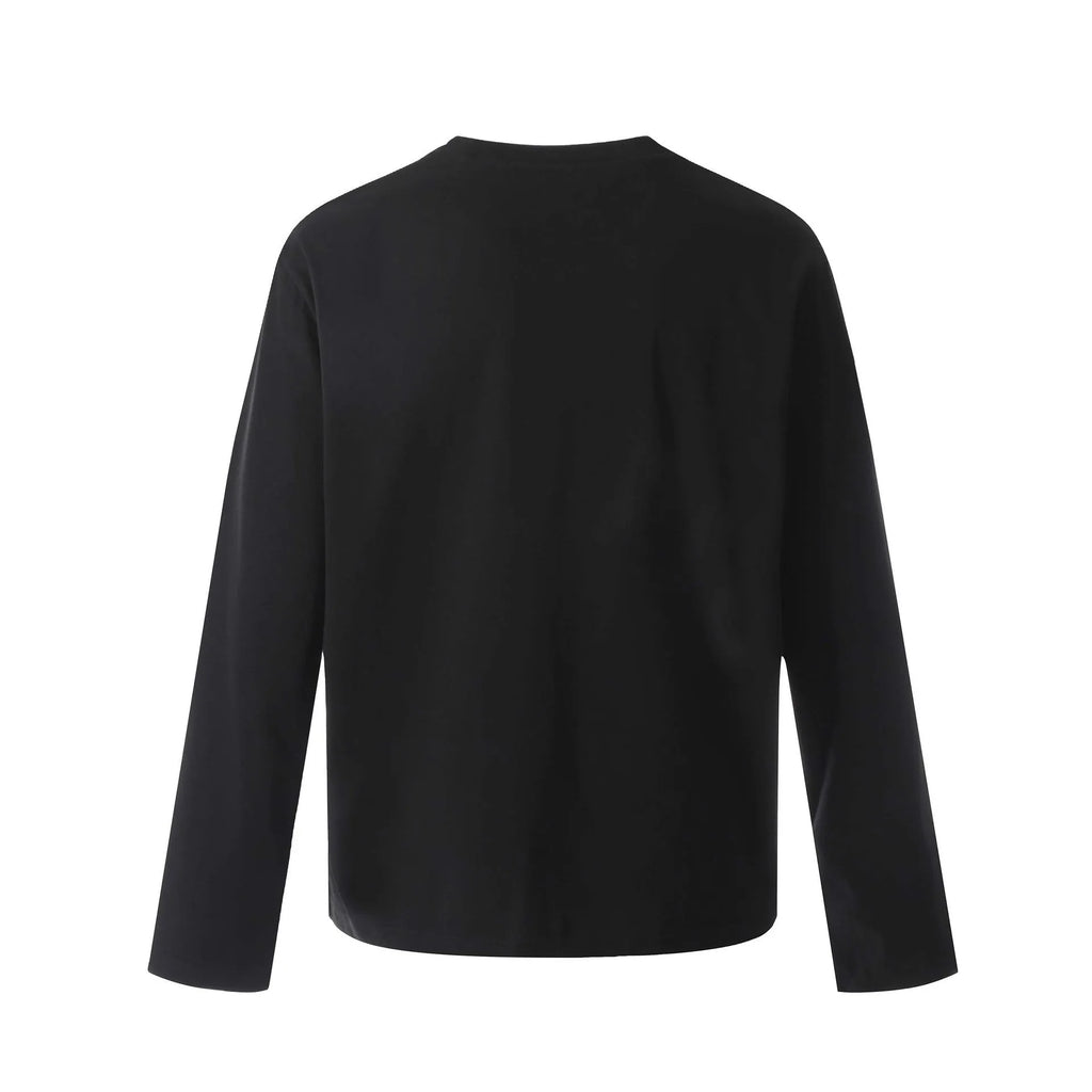 Man wearing a black loose-fit cotton long sleeve casual top.