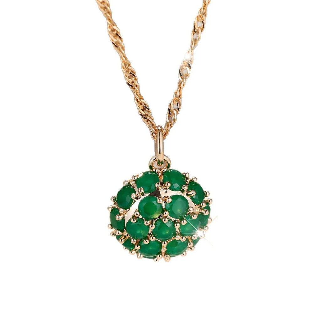 Champagne gold necklace with round emerald pendant and full diamond setting on an adjustable chain.