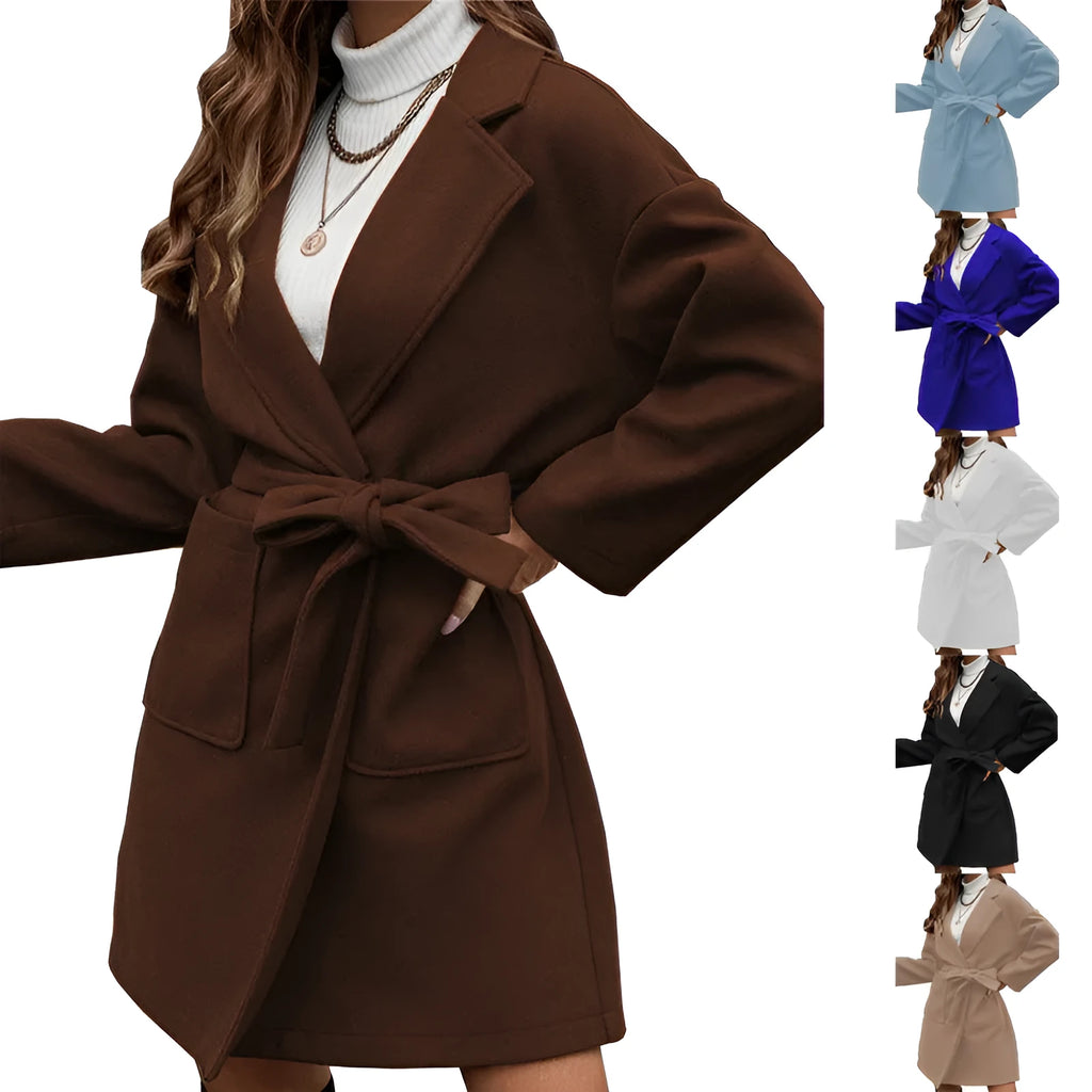 Minimalist long sleeve lapel coat with a split belt in a light blue colour, shown on a model.