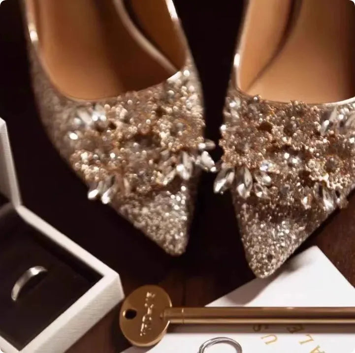 Champagne Xiuhe wedding shoes with rhinestone flower pattern and pointed toe on a fine heel.
