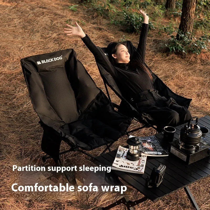 Black folding camping recliner with Oxford cloth seat, shown in outdoor setting
