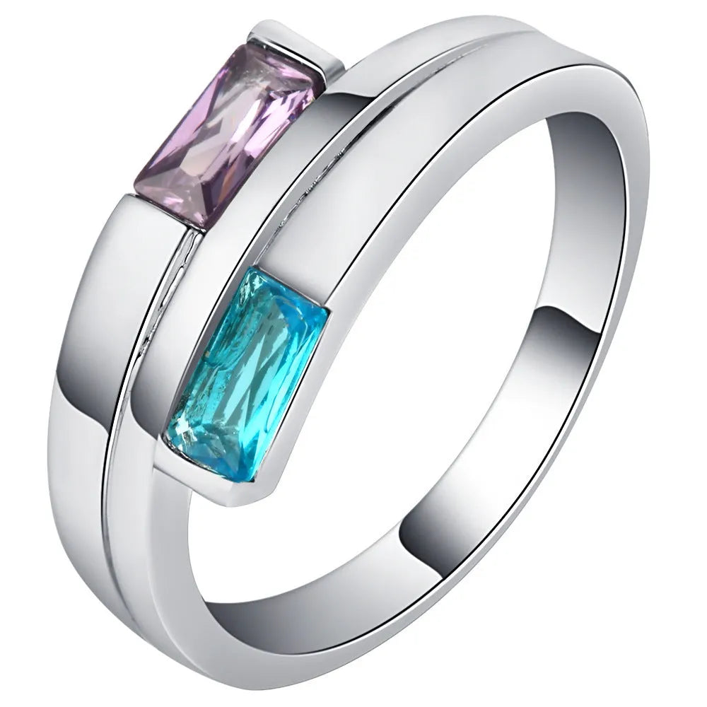 Silver-coloured copper ring with a central zircon stone, shown on a hand.
