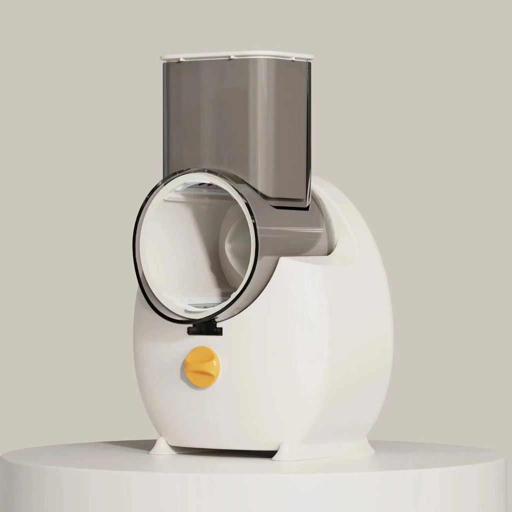 White electric vegetable slicer with interchangeable blades and suction base on a kitchen counter