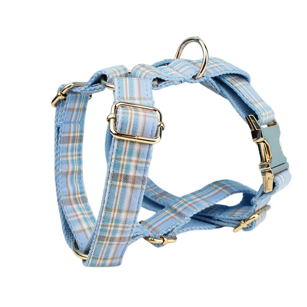 Sky blue and white grid pattern dog collar, leash, bow, and vest four-piece pet accessory set.