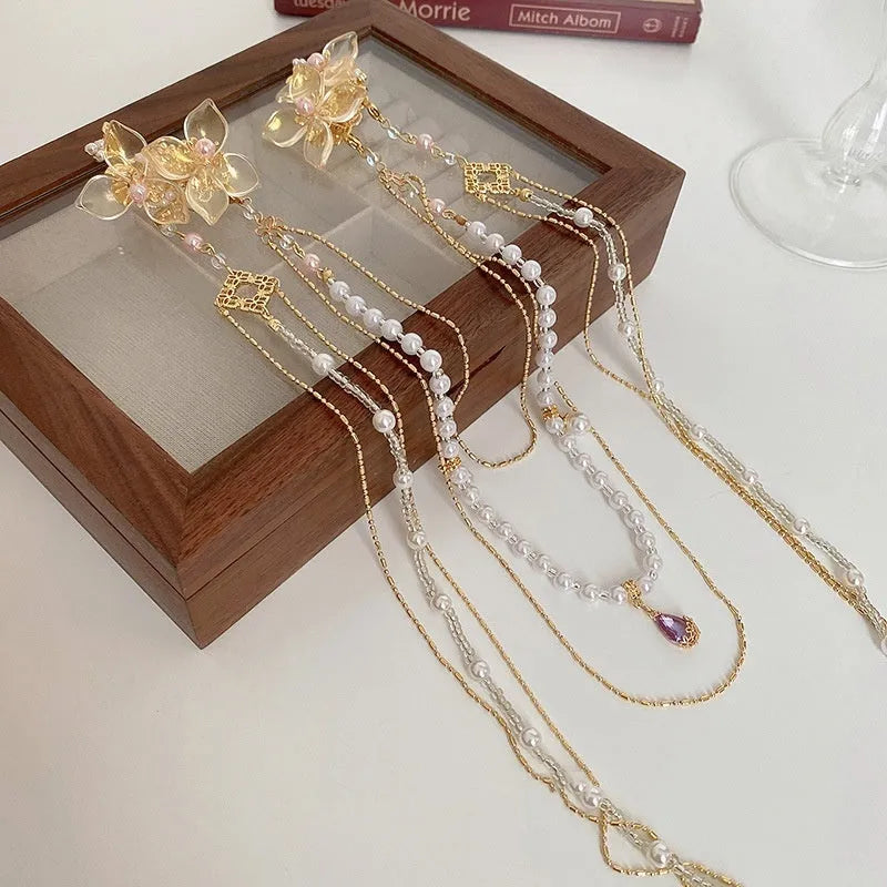 Women's pearl diamond flower long tassel hairpin with gold grip and decorative elements