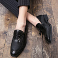 Men's black pointed slip-on leather shoes with tassel detailing on a low-top upper for business wear