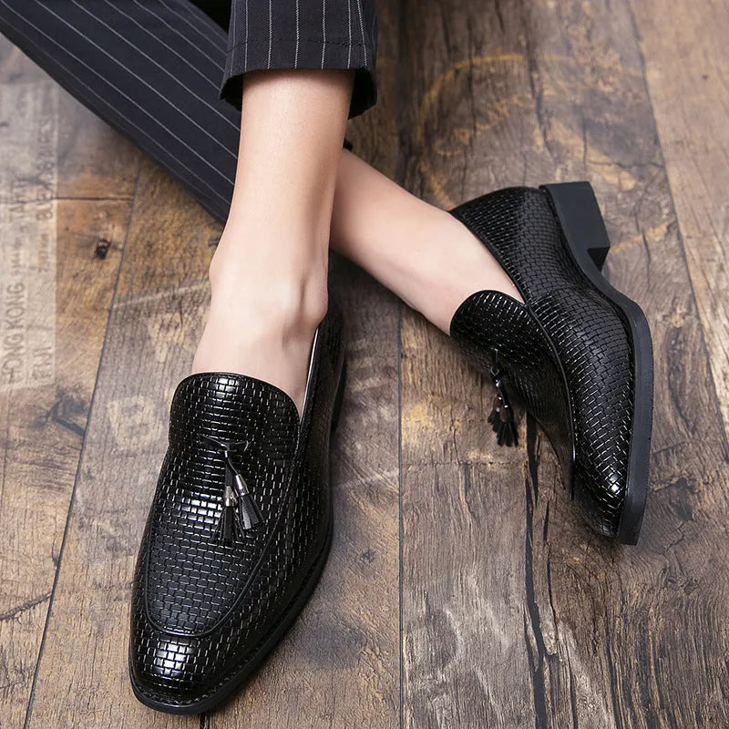 Men's black pointed slip-on leather shoes with tassel detailing on a low-top upper for business wear