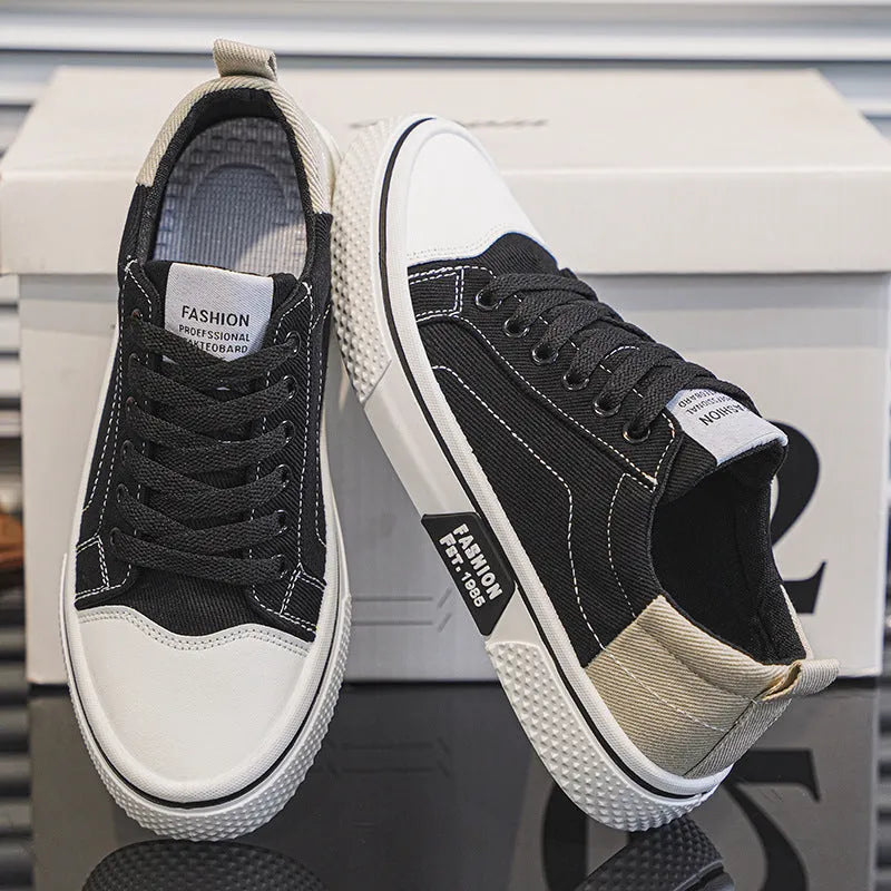Men's low-top blue canvas shoes with round toe and white stitching on a soft PVC sole.