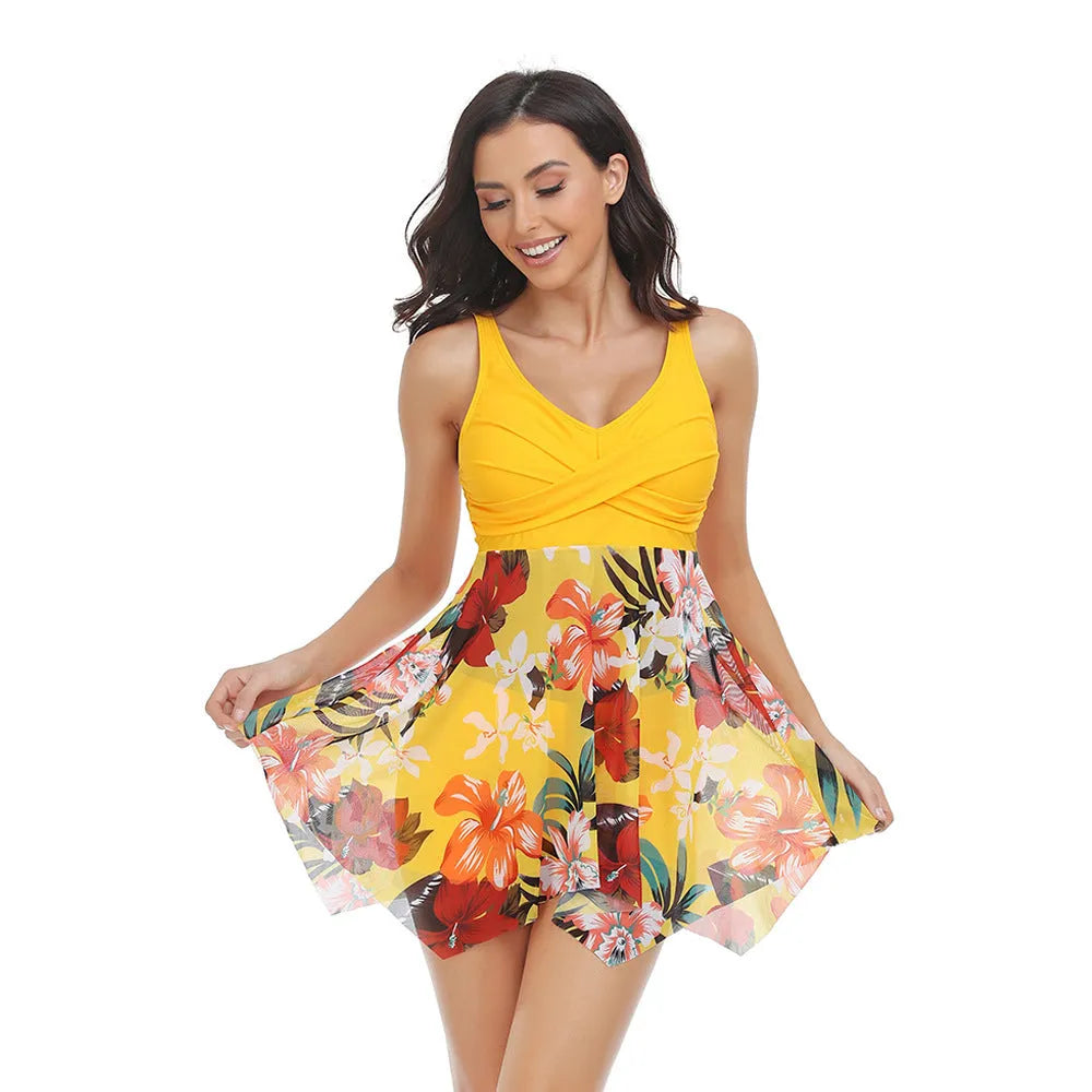 Women's black one-piece swimsuit with a sheer tulle skirt and high-leg split.