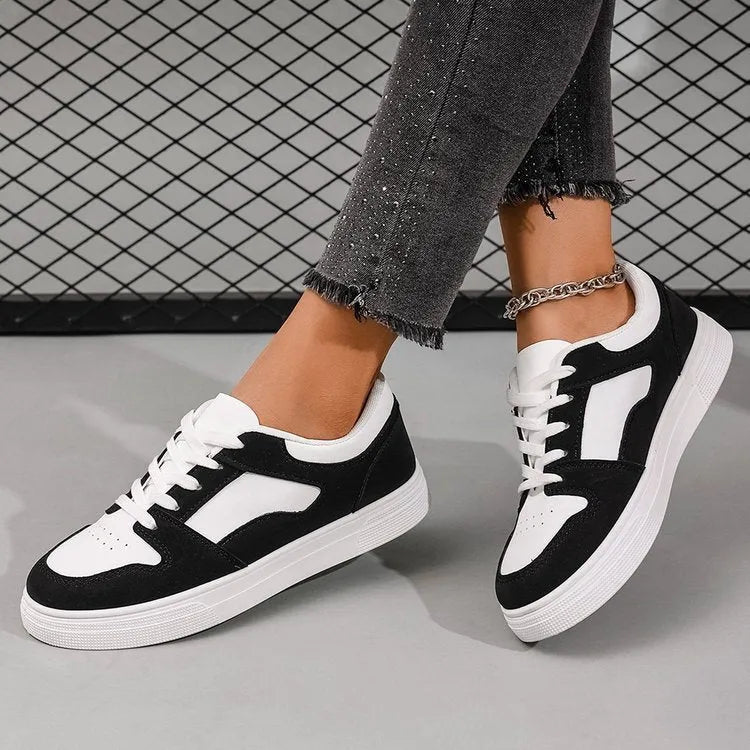 Black women's casual sports shoes with artificial PU upper and rubber sole, showing round toe and lace-up design