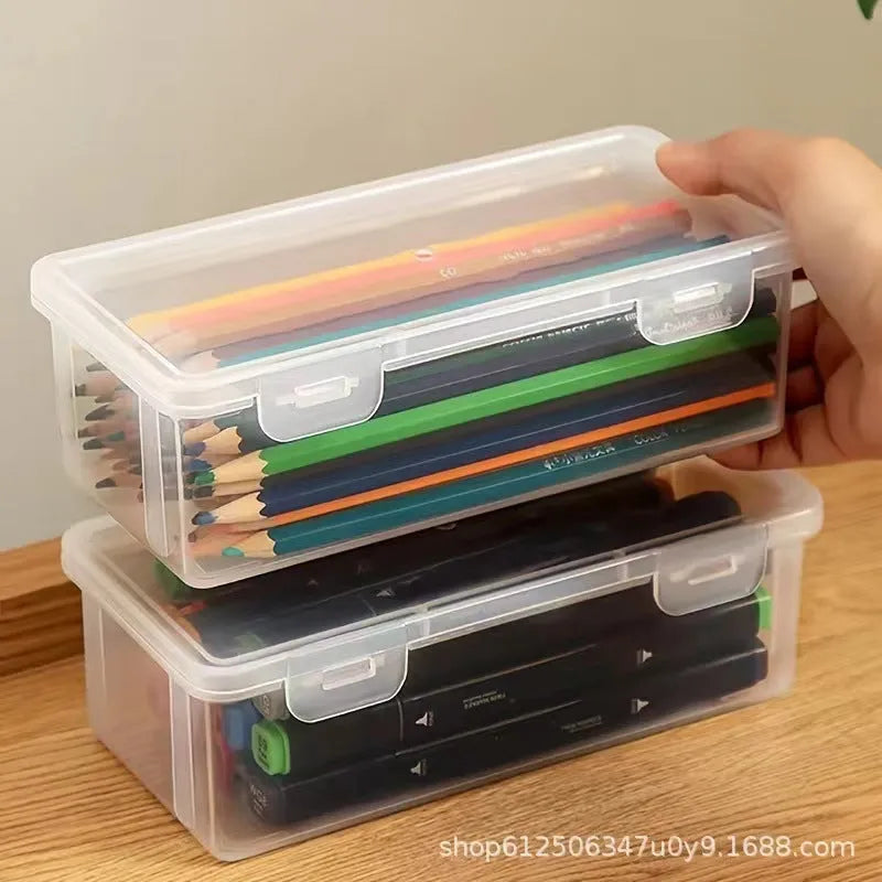 Transparent plastic stationery storage box with snap-lock lid containing coloured pencils and pens