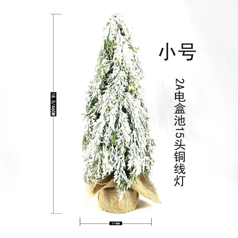 24-inch desktop Christmas tree with PE snow simulation and integrated lighting on wooden surface