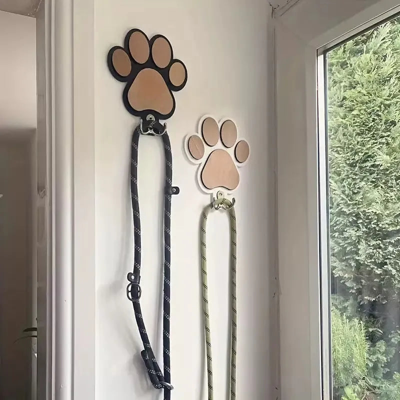 Black wooden wall hook shaped like a paw print for hanging coats and keys