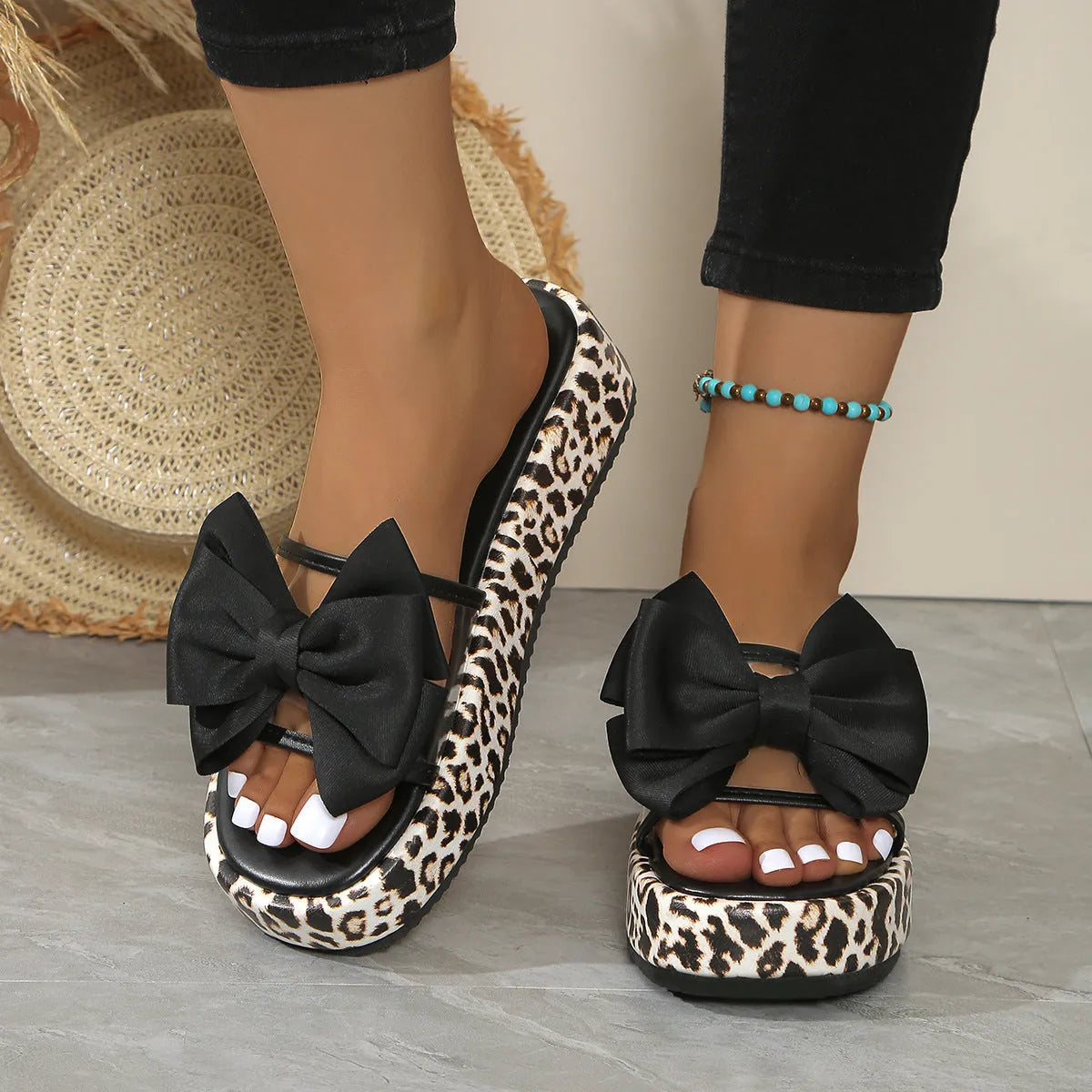 Women's leopard print beach slippers with thick sole and round toe in black and white options