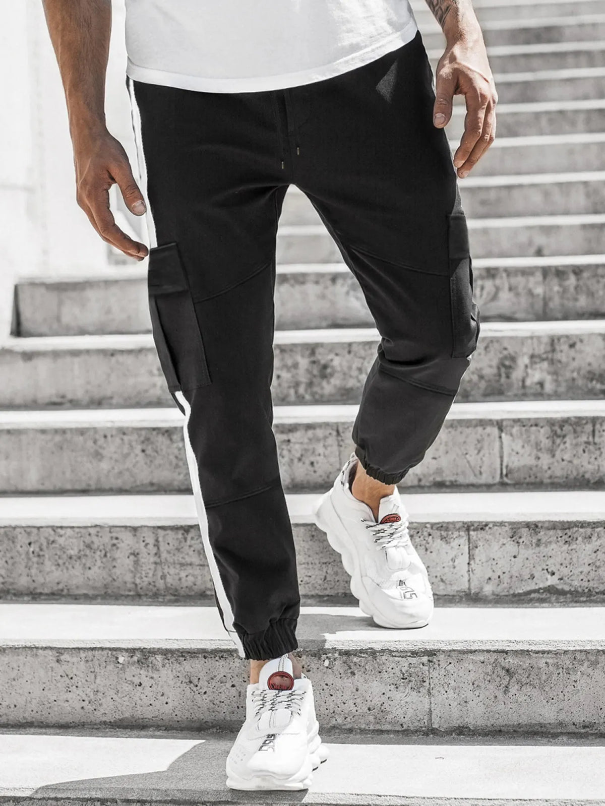 Men's leather-look casual trousers in khaki, black, or dark grey with middle waist and zip fly.