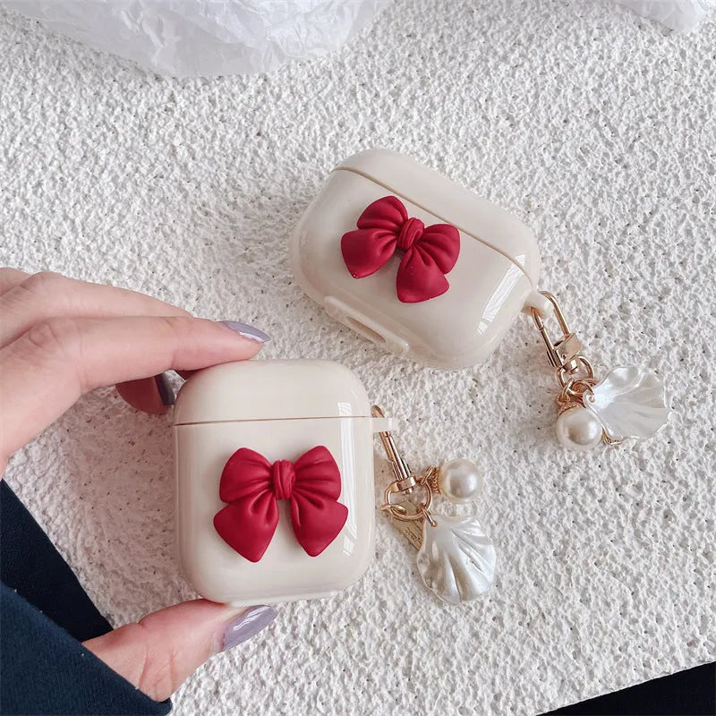 Beige TPU clamshell earphone case with a red bow design for AirPods.