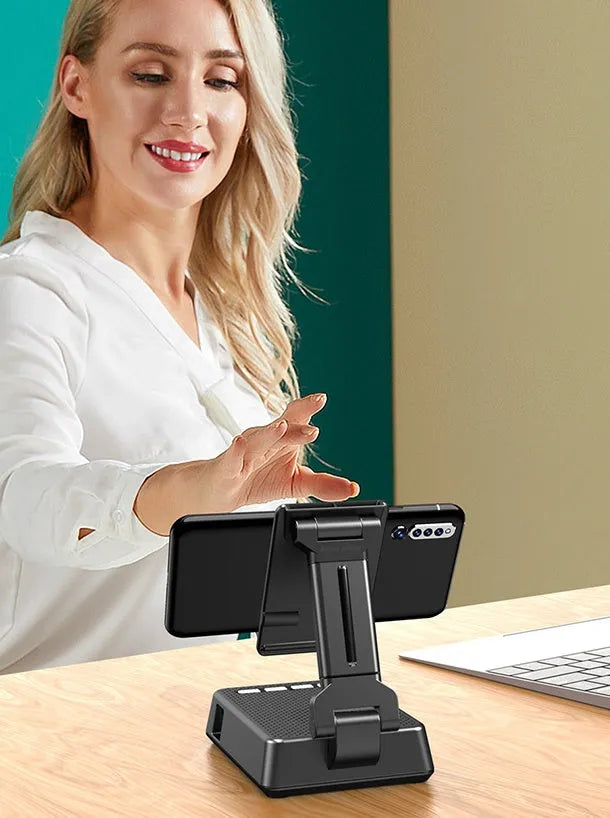 Black mobile phone stand with Bluetooth speaker on desk showing 135cm height and USB charging port