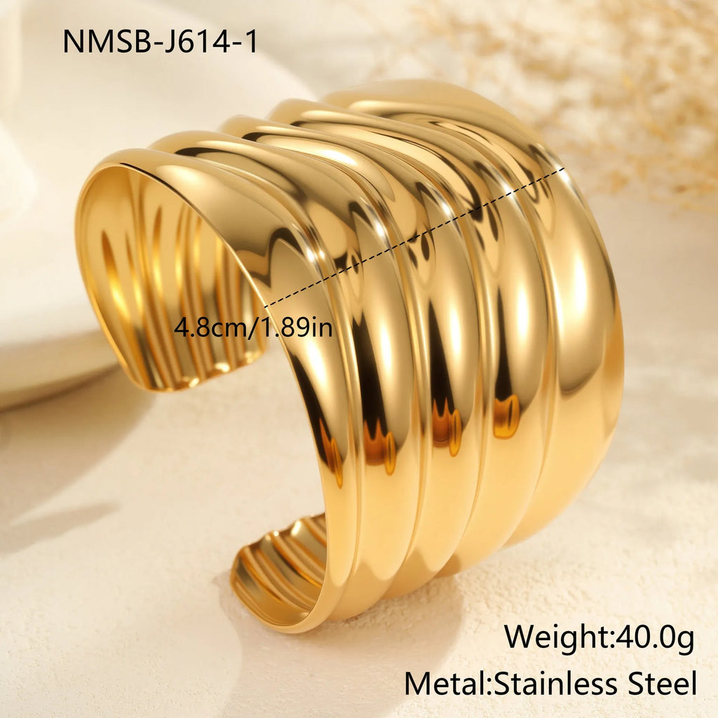 Gold plated wide women's bracelet with asymmetric geometric design and a niche opening.