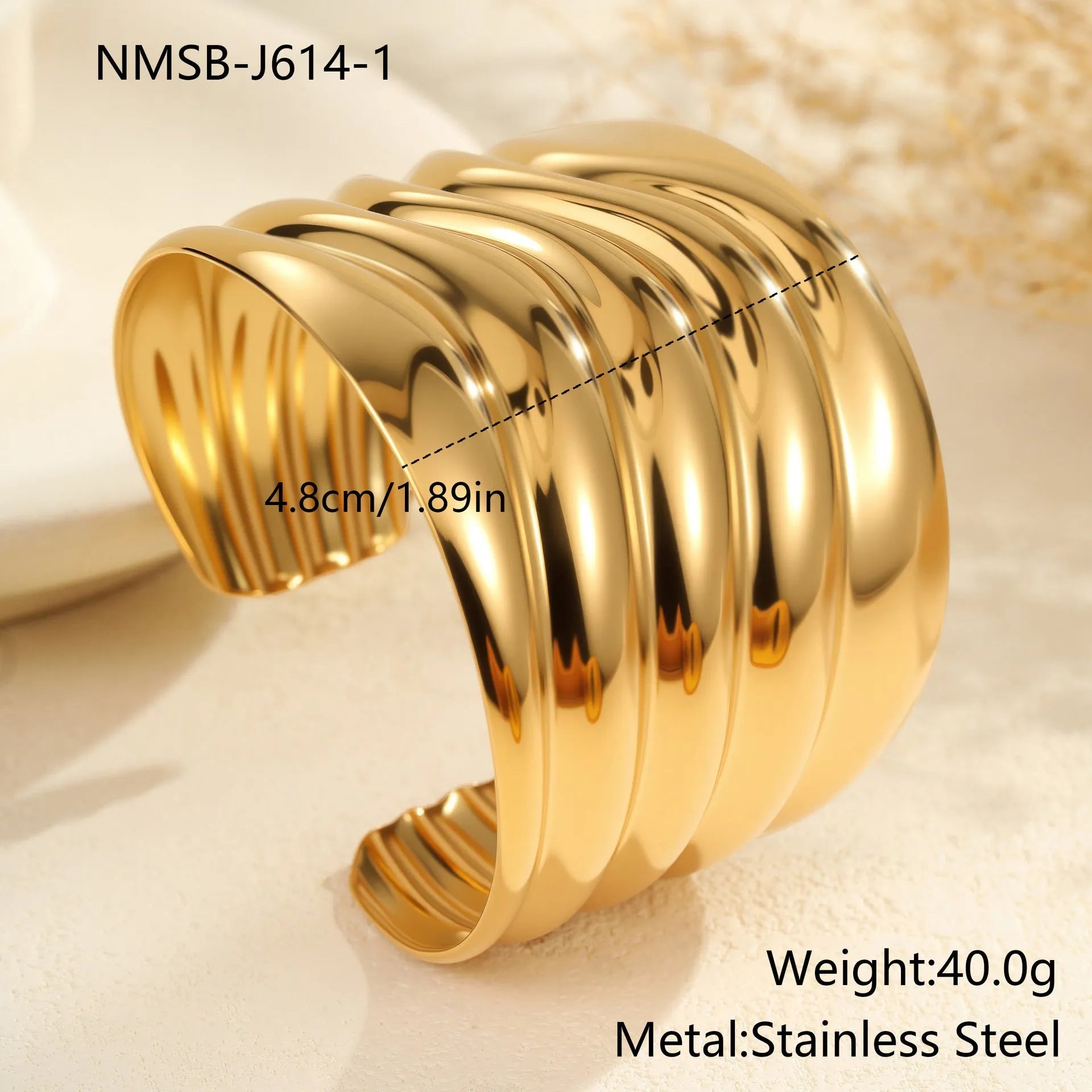 Gold plated wide women's bracelet with asymmetric geometric design and a niche opening.